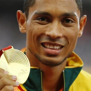 Wayde van Niekerk of South Africa presents his gold medal as he poses on the podium after the men's 400 metres final during the 15th IAAF World Championships at the National Stadium in Beijing, China, August 27, 2015. REUTERS/Damir Sagolj